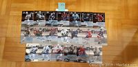 Photo showing twenty autographed 2002 ITG hockey cards arranged in four rows on a wood floor.