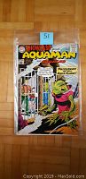 Front cover of Showcase #33 comic book featuring Aquaman and Aqualad with a green alien character and comic price 10 cents.