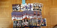 Photo showing over 80 Wayne Gretzky hockey cards arranged on a wooden floor, including 52 Memorable Moments NHCD-16 cards and cards depicting Gretzky in Edmonton Oilers and Los Angeles Kings uniforms.