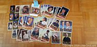 Fifty-nine 2011 Goodwin Champions hockey cards laid out on a wooden floor, showing various hockey stars in portrait and action shots.