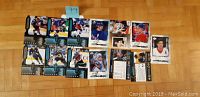 Photo showing thirteen 1999 Upper Deck hockey card inserts including notable players Wayne Gretzky, Patrick Roy, and Jaromir Jagr Rookie Rewind.