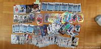 Photo shows over 150 hockey card inserts and numbered cards arranged on a flat surface including multiple card styles and designs.