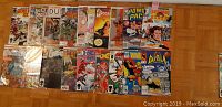 Photo showing 18 Marvel comics #1 in a grid on a wooden floor.