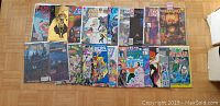 Full top-down view of 22 comic books laid out revealing various titles and cover art.