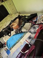 Photo of assorted purses, handbags, scarfs, and belts laid out showing a variety of colors and styles.