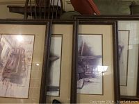 Four vintage framed prints leaning against a surface, showing partial details of rustic art prints by Gene Franks