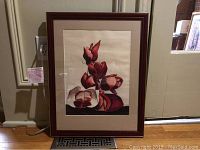 Frontal view of framed watercolor flower painting showing the floral design, matting, and wooden frame.