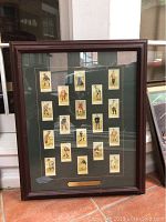 Full view of the framed golfer tobacco cards showing 18 cards arranged with green mat and dark brown wooden frame.