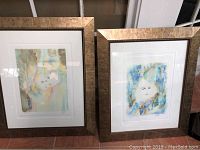 Pair of signed watercolor prints front view in matching gold textured frames