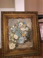 Full view of the framed painting showing a floral bouquet in a blue vase dated 1969.