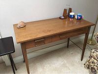 Vintage wooden desk with linear Scandinavian design and original hardware.