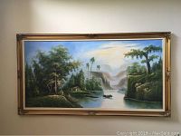 Full view of the large framed oil painting showing the entire scenic landscape including river, trees, and sky.