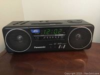 Front view of Panasonic clock radio showing digital time display and stereo speakers