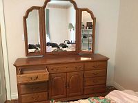 Front view of oak dresser with tilt mirror, left drawer open
