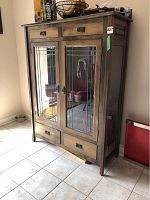 Front view of wood hutch showing two glass doors, top drawers and bottom drawers