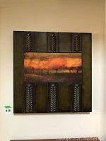 Full view of square metal wall art measuring 31x31 inches mounted on wall, showing central tree print and textured metal with leaf motifs.