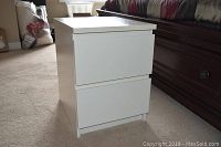 White laminate side table with two drawers and clean, modern design