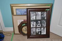 Four assorted framed artworks including decorative plate, collage frame, floral print, and larger art piece