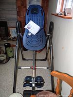 Front view of inversion table with owner's manual placed on backrest