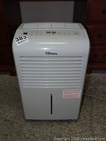 Front view of white Danby Premiere dehumidifier showing vent grille and control panel.