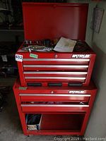 Front view showing two stacked red Waterloo tool cabinets with multiple drawers and an open bottom shelf.