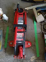 Top view of the red Mastercraft hydraulic trolley jack showing the lifting pad and handle attachment point.