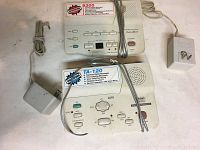 Photo of Casio Phone Mate tape-less digital message recorders with microphones and power adapters on a white surface
