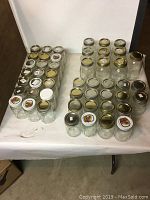 Top-down angled photo showing an array of Mason jars including pint, half-pint, and quart sizes arranged at different depths.