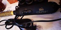 Close-up photo of black Tsanis Ceramix hair dryer with multiple heat settings and attached power cord.