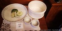Top view of set showing pie plate with fruit design, two ramekins, and large bowl/planter.