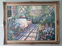 Full frontal view of framed painting showing garden terrace scene and ornate frame