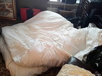 King size feather bed spread out showing off-white thick feather filling.