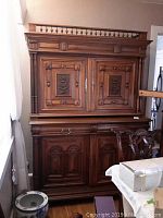 Full front view of the three-piece ornate server cabinet showing upper hutch and lower cabinet
