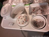 Top view showing all dishes, including Jardin covered oval and round dishes with floral border and Mikasa oval and rectangular dishes with floral design.