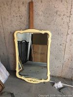 Front view of French Provincial style wall mirror with cream carved frame and attached wooden board behind it, showing ornate details and size.