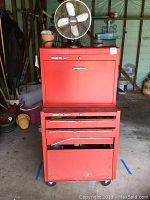 Red Stack On tool cabinet with multiple drawers and compartments, some soiling and rust visible.