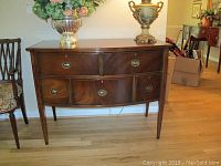 Front view of breakfront sideboard showing full facade, drawer arrangement and hardware