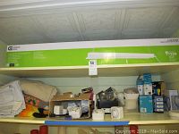 LED shoplight fixture in box, assorted bulbs and timers, shelf storage
