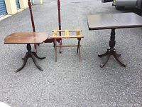 Two vintage wooden tables and two wooden racks placed outdoors on asphalt, showing condition and structure of each item.