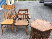 Four wooden chairs positioned next to each other with visible scratches and nicks in finish.