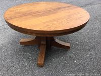Top view of vintage round wood dining table showing wood grain and surface finish.