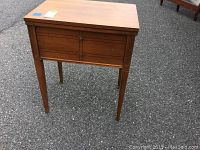 Front and side view of vintage Sears sewing machine table showing four straight legs and rectangular top with some scratches and marks.