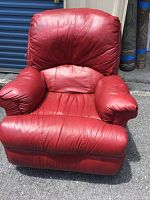 Front view of red leather-type rocker recliner chair showing overall condition and shape