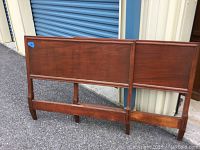 Pair of twin size wooden headboards showing front view and condition with scratches and nicks in finish.