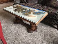 Full view of rectangular Italian marble top table with glass cover and painted knights design. Wooden pedestal base visible.