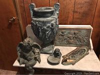 Photo showing the full set including Italian urn, cherub statue, cherub tile, small cherub dish, and mirror placed on a marble surface.