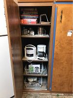 Full shelf view showing all items in the lot including appliances, jars, sifter, and cookbooks.