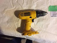 Top down view of yellow and black DeWalt cordless drill driver showing side with motor vents and label plate.