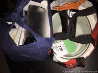 Two bags filled with various kitchen items including slow cooker, milk bag jugs, box, and coffee grinder.