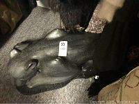 Sculpted plaster panther table base, showing side view and detail of texture.